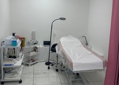 Modern treatment room at Aesthetic Beauty Clinic, Kingston Upon Thames, England, GB with equipment and bed.