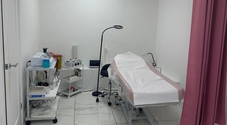Modern treatment room at Aesthetic Beauty Clinic, Kingston Upon Thames, England, GB with equipment and bed.