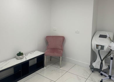 Cozy corner at Aesthetic Beauty Clinic, Kingston Upon Thames. Features chic pink chair and modern equipment.
