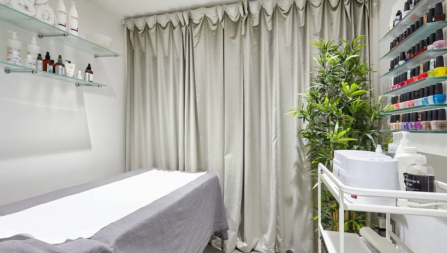 AF Beauty treatment room with cozy bed and beauty products in Kingston Upon Thames, England, GB.