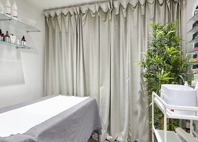 AF Beauty treatment room with cozy bed and beauty products in Kingston Upon Thames, England, GB.