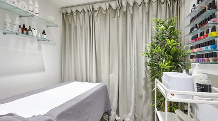 AF Beauty treatment room with cozy bed and beauty products in Kingston Upon Thames, England, GB.
