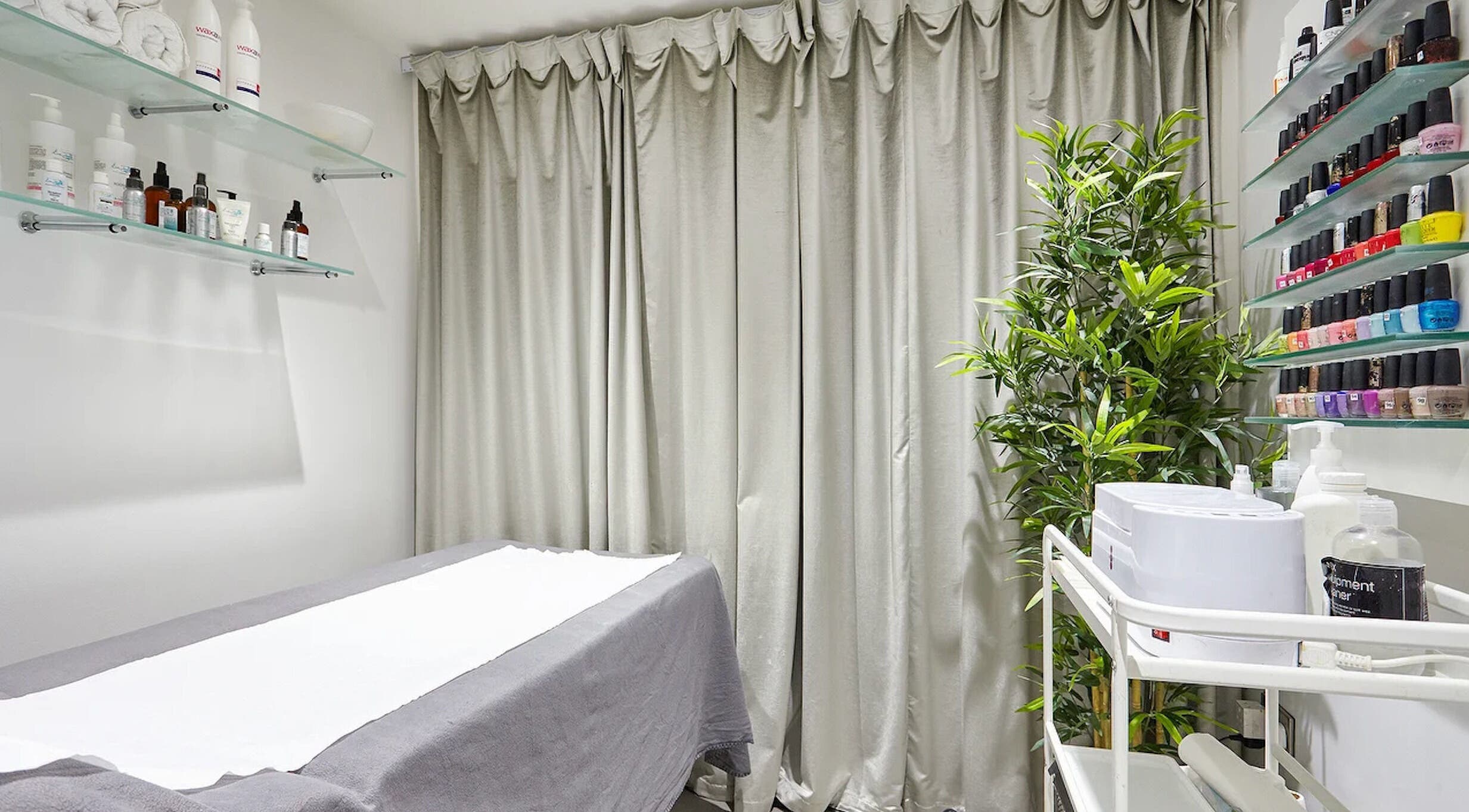 AF Beauty treatment room with cozy bed and beauty products in Kingston Upon Thames, England, GB.