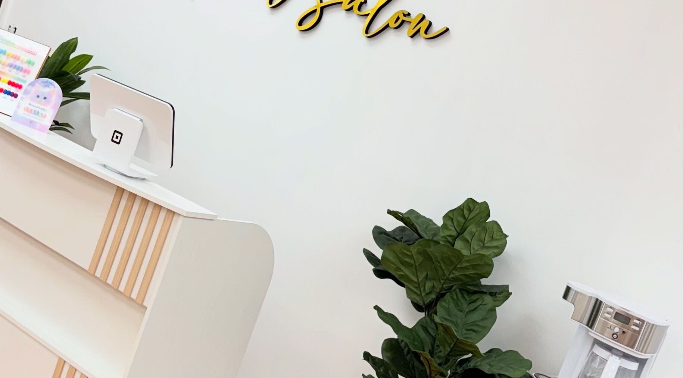 Modern reception at Uxua’s Nail Salon, Clifton, New Jersey, US, featuring sleek decor and indoor plant.