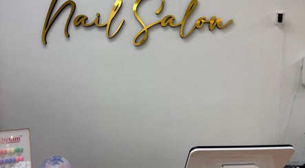 Elegant gold 'Nail Salon' sign at Uxua’s Nail Salon, Clifton, New Jersey, US.