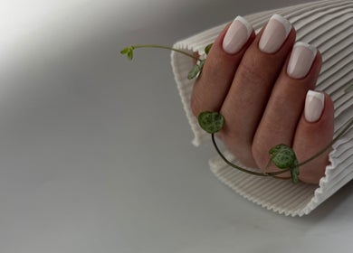 Elegant French manicure at DK Nail Aesthetician in Sutton, England, GB with delicate white tips.