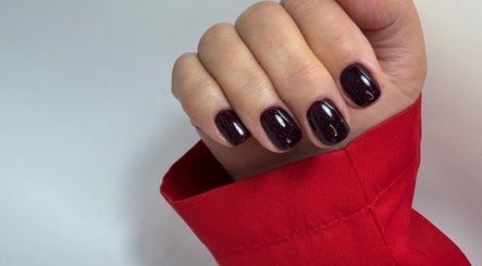 Elegant dark red manicure at DK Nail Aesthetician in Sutton, England, GB, showcasing glossy nail polish.