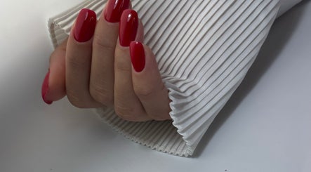 Close-up of polished red nails at DK Nail Aesthetician, Sutton, England, GB. Perfect for chic hand aesthetics.