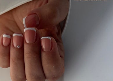 Elegant French manicure at DK Nail Aesthetician, Sutton, England, GB. Featuring classic white tips.