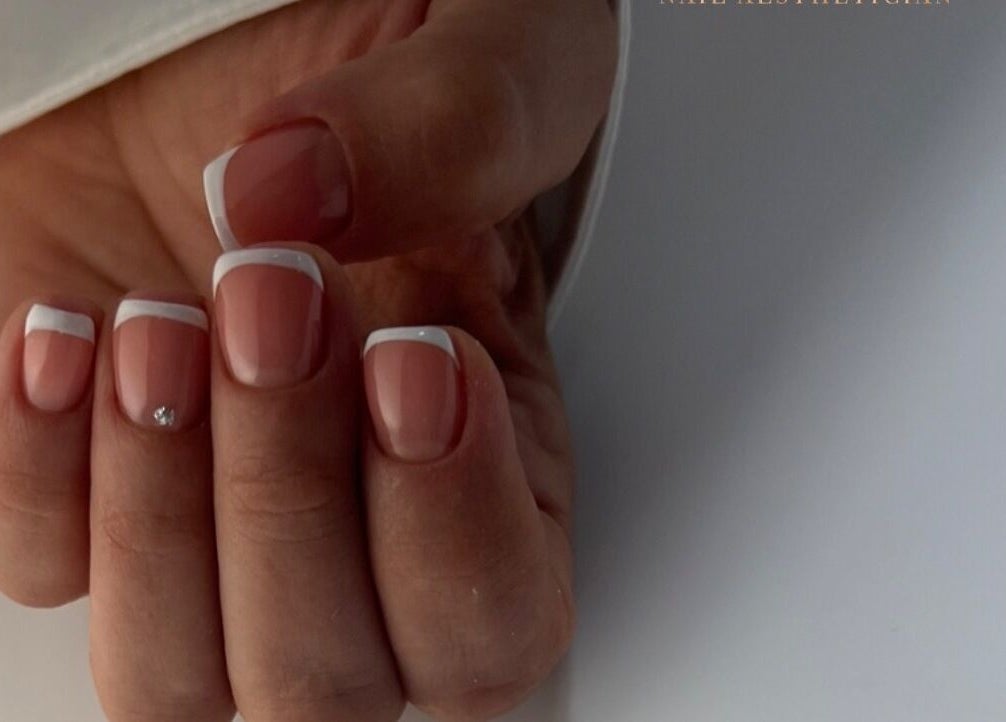 Elegant French manicure at DK Nail Aesthetician, Sutton, England, GB. Featuring classic white tips.