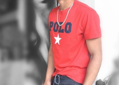 A stylish person in red shirt at REFINED BARBERSHOP, Paignton, England, GB offering premium services.