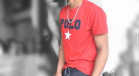 A stylish person in red shirt at REFINED BARBERSHOP, Paignton, England, GB offering premium services.