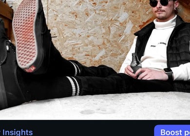 Person relaxing at REFINED BARBERSHOP, Paignton, England, GB in casual attire, holding a beverage.