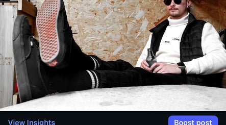 Person relaxing at REFINED BARBERSHOP, Paignton, England, GB in casual attire, holding a beverage.