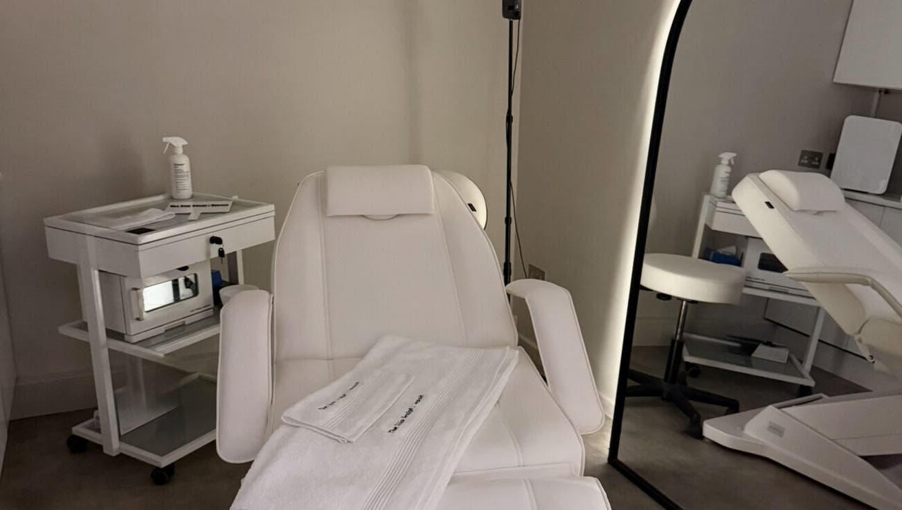 Relaxing treatment room at The Skin Sculpt Consult in Southport, England, GB with plush white chairs.