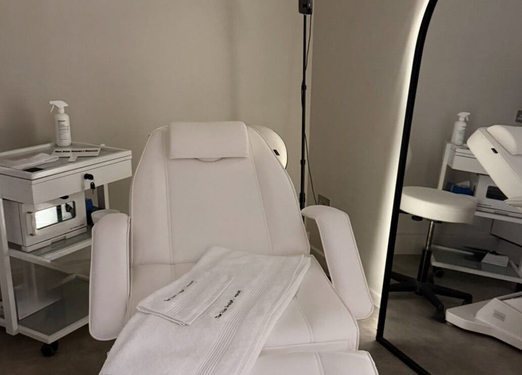 Relaxing treatment room at The Skin Sculpt Consult in Southport, England, GB with plush white chairs.