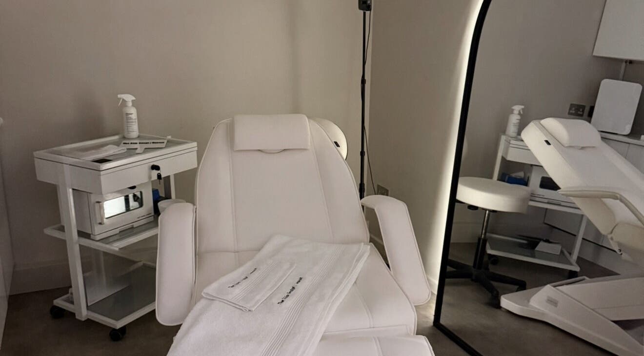 Relaxing treatment room at The Skin Sculpt Consult in Southport, England, GB with plush white chairs.