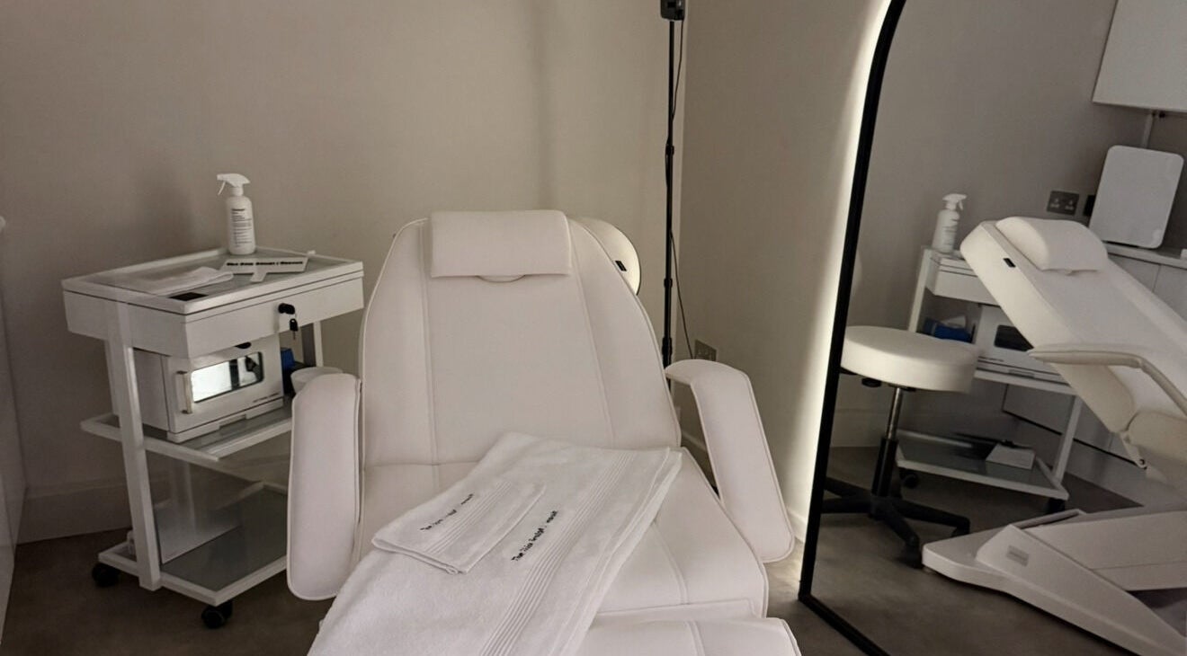 Relaxing treatment room at The Skin Sculpt Consult in Southport, England, GB with plush white chairs.