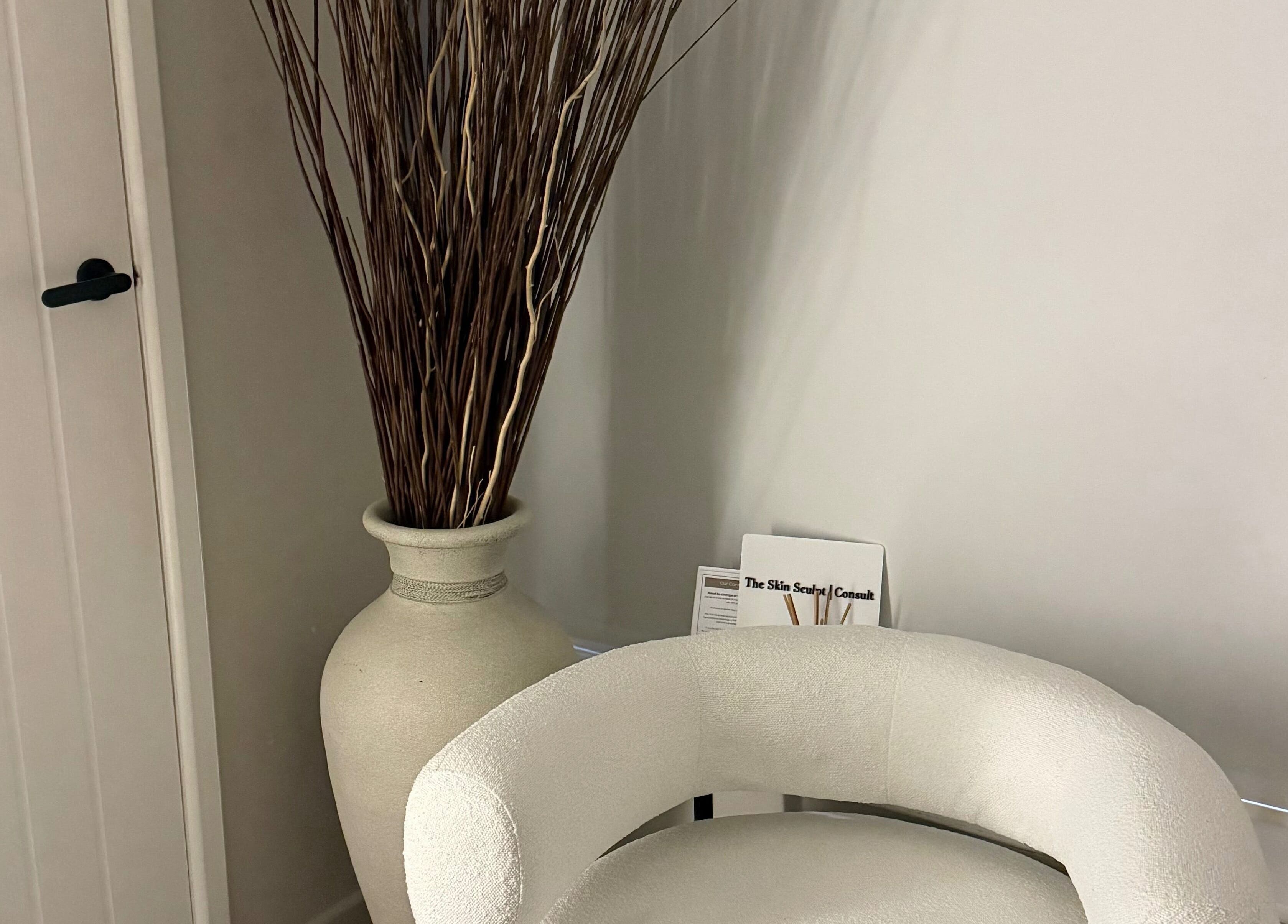 Elegant corner with plush chair and vase at The Skin Sculpt Consult, Southport, England, GB.
