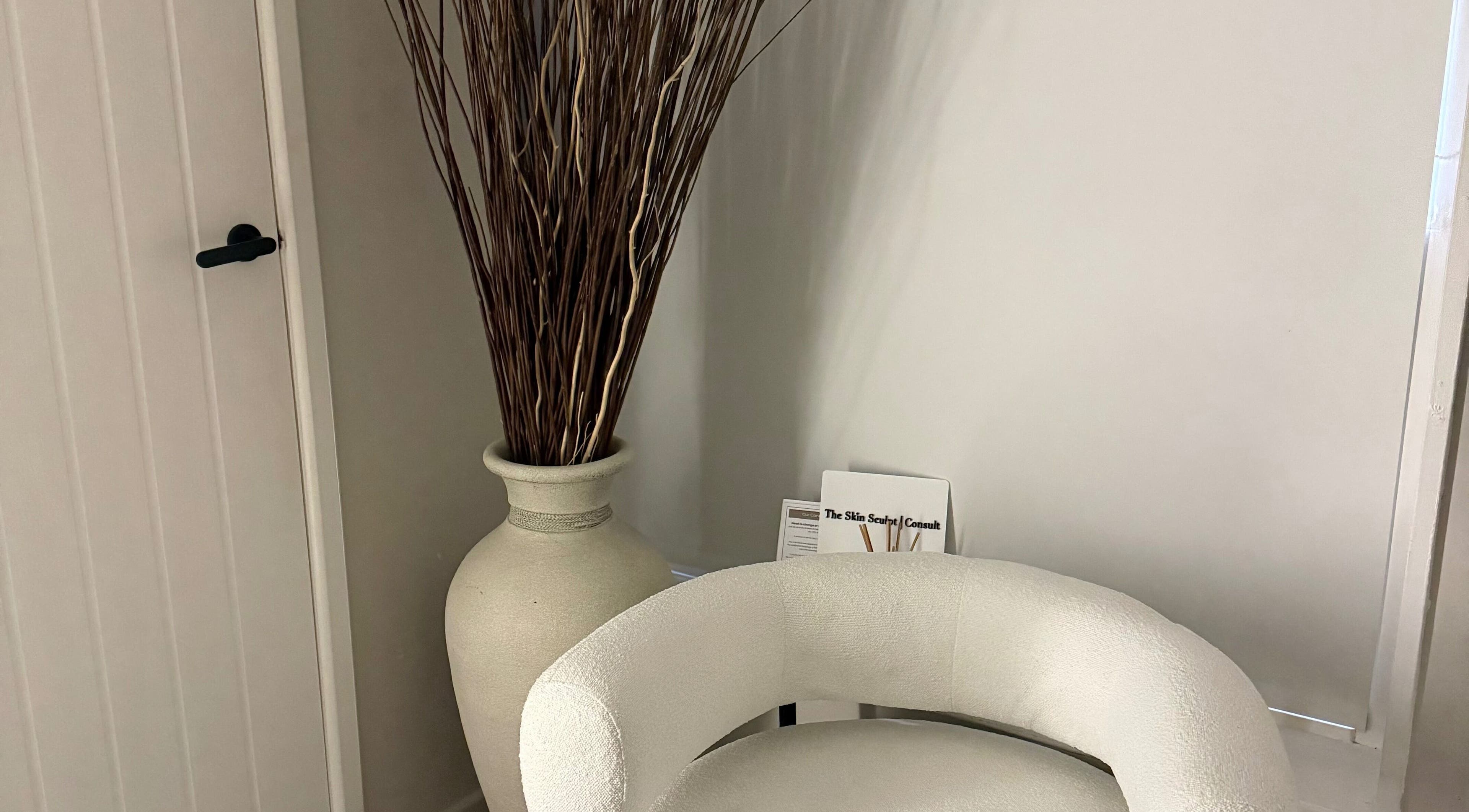 Elegant corner with plush chair and vase at The Skin Sculpt Consult, Southport, England, GB.