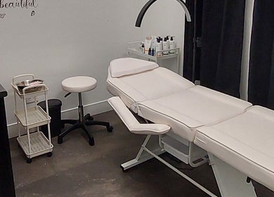 Cozy treatment room at Elena Danileiko Spa in Kelowna, British Columbia, CA with massage table and supplies.