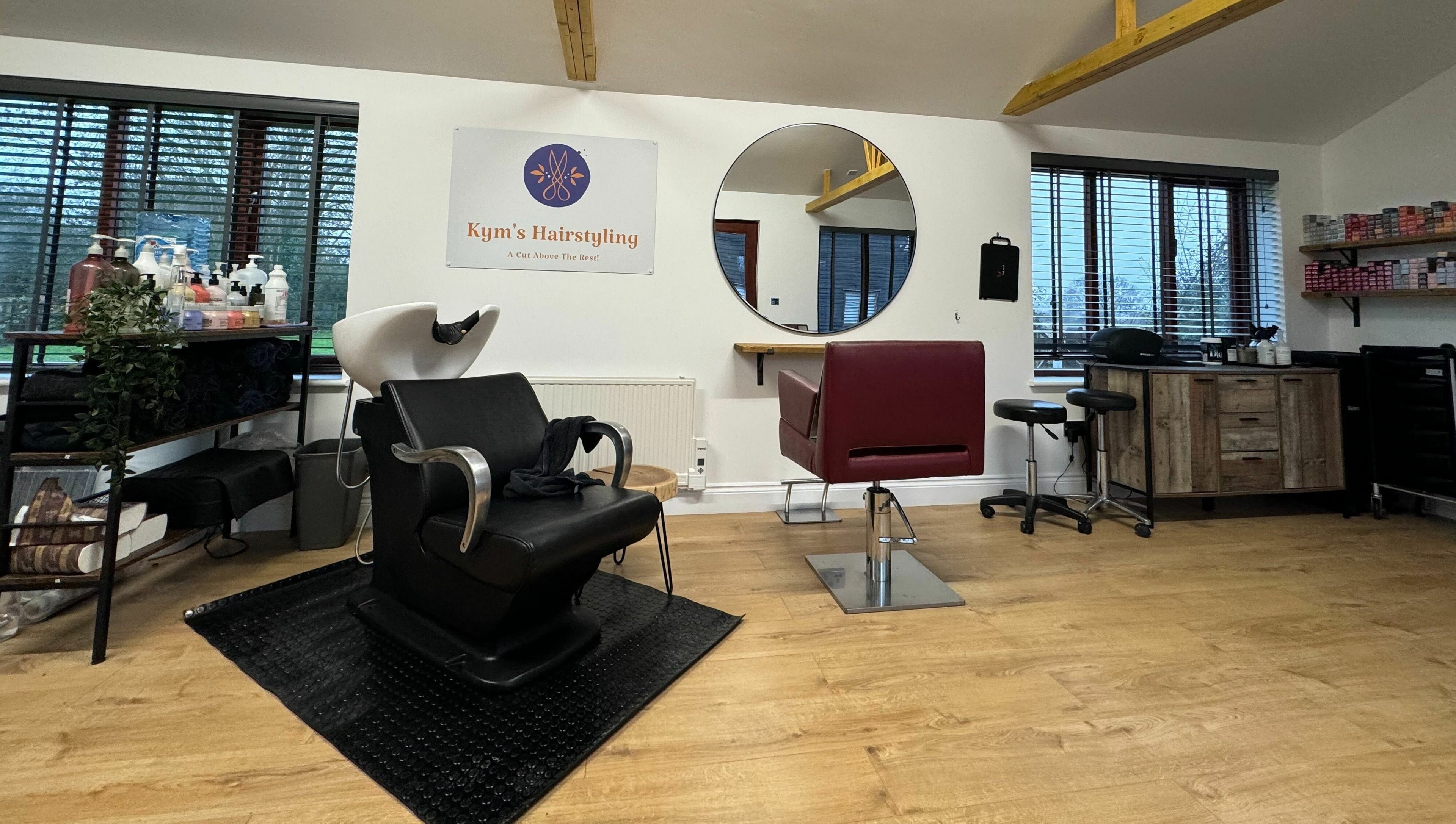 Chic interior of Kym's Hairstyling, Gaddesden Row, England, GB with sleek styling chairs and modern decor.