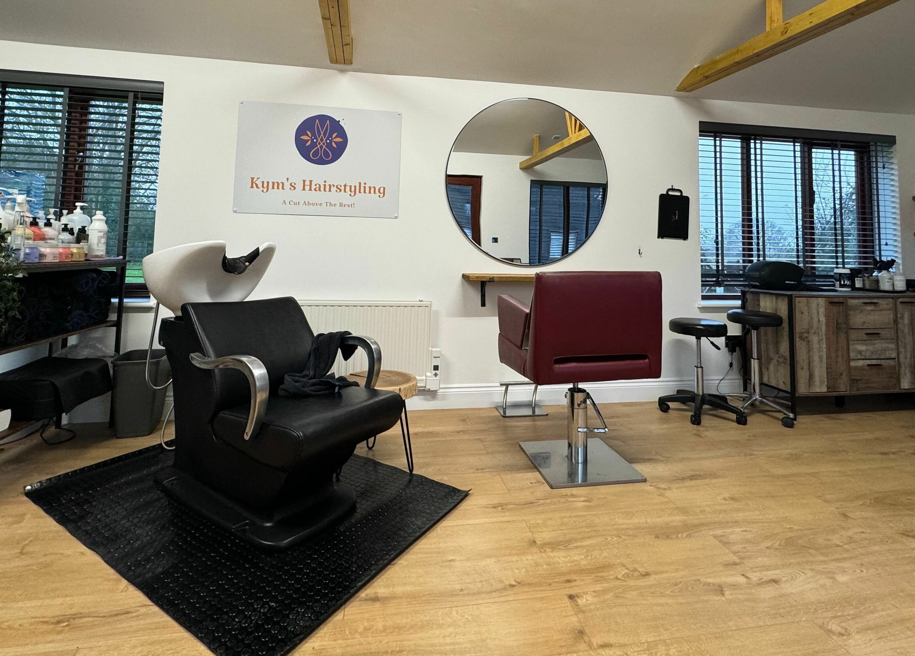 Chic interior of Kym's Hairstyling, Gaddesden Row, England, GB with sleek styling chairs and modern decor.