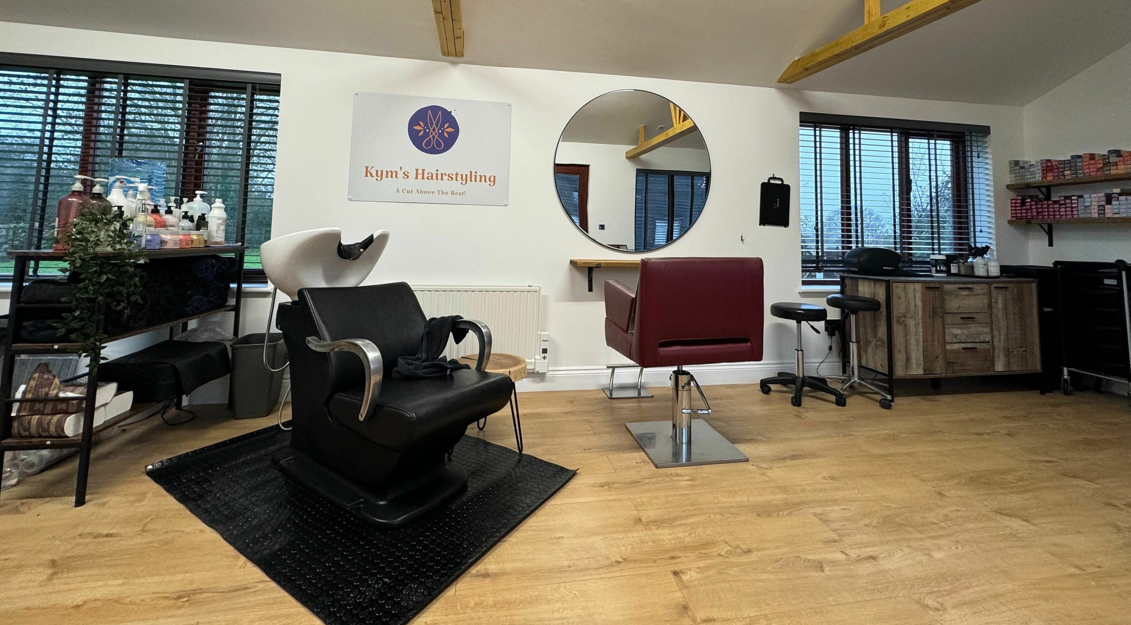 Chic interior of Kym's Hairstyling, Gaddesden Row, England, GB with sleek styling chairs and modern decor.