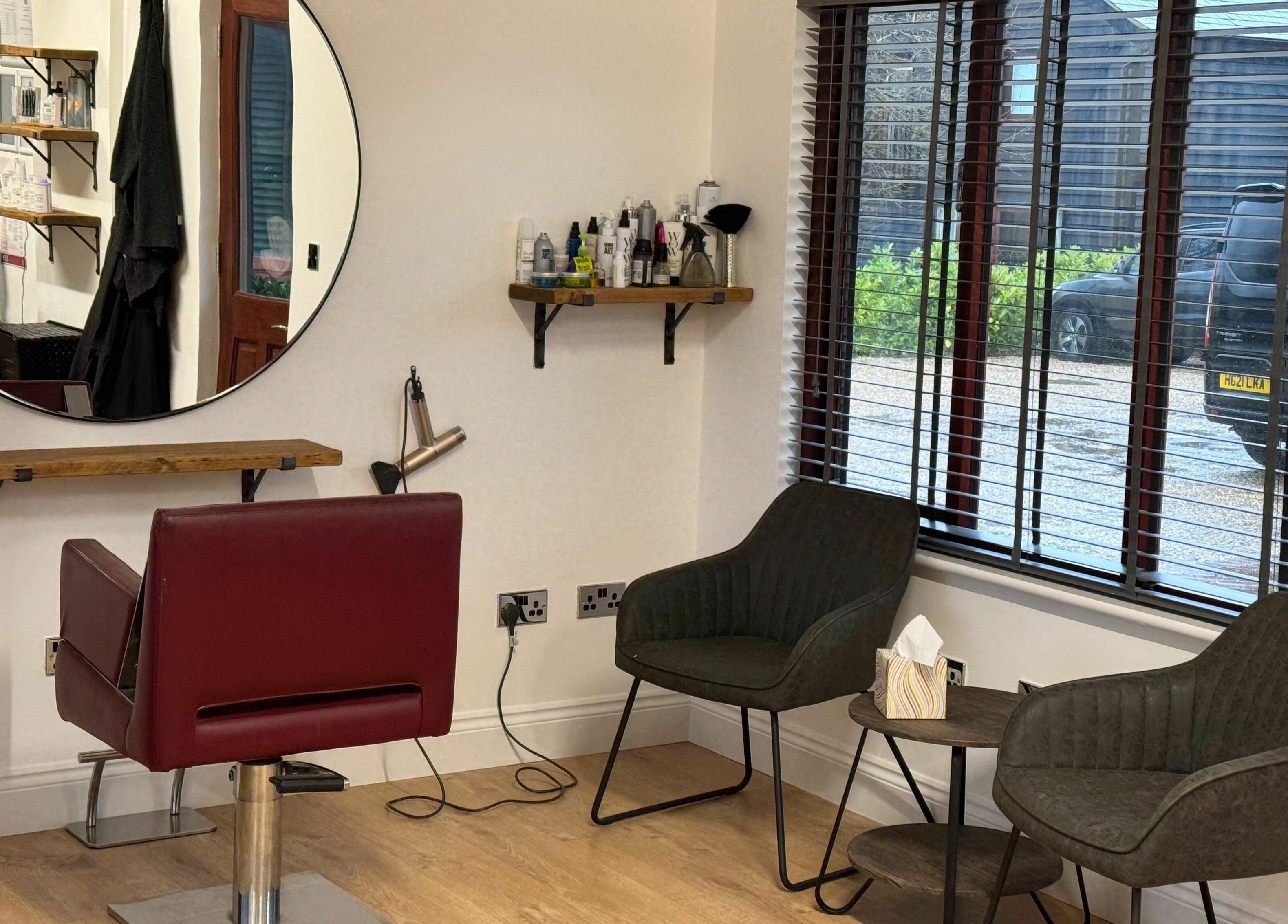 Interior of Kym's Hairstyling, Gaddesden Row, England, featuring elegant styling chair and modern decor.