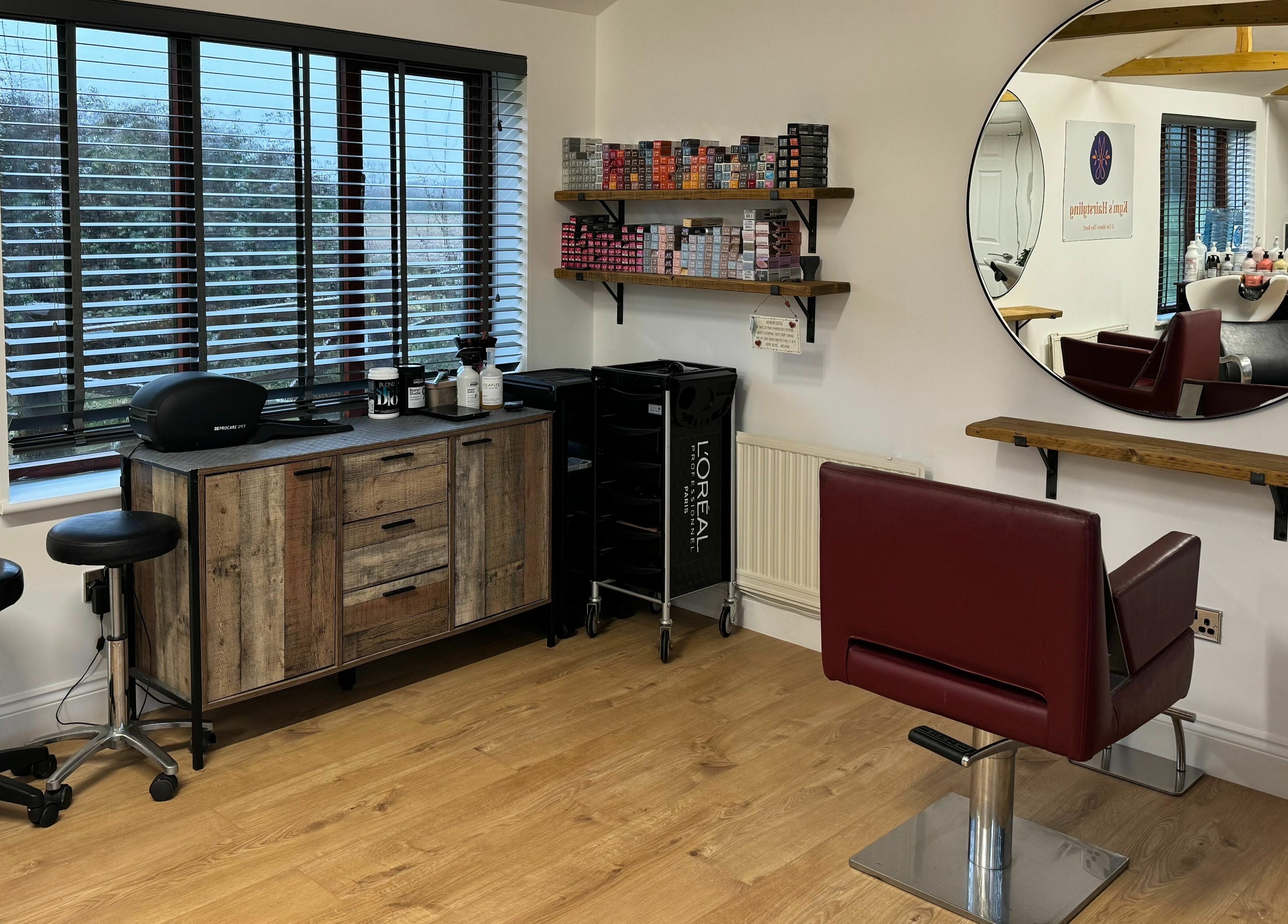 Modern salon interior at Kym's Hairstyling, Gaddesden Row, England, GB featuring a chic styling station.