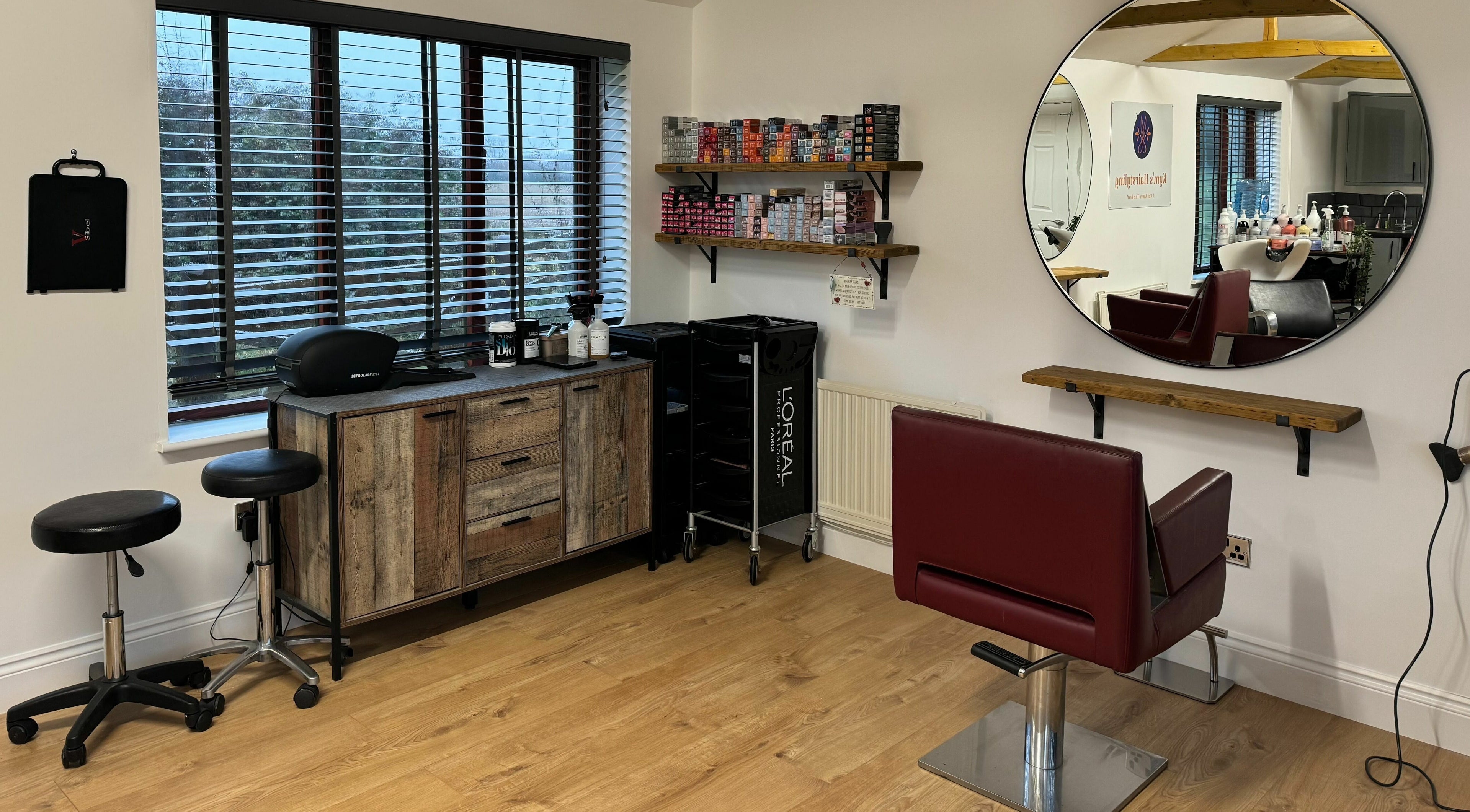 Modern salon interior at Kym's Hairstyling, Gaddesden Row, England, GB featuring a chic styling station.