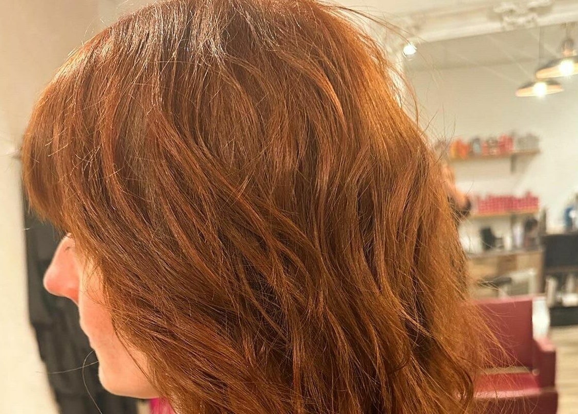 Side view of styled copper hair at Kym's Hairstyling, Gaddesden Row, England, GB.