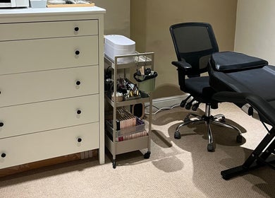 Treatment room at The Hatters Beauty Room, Finedon, England, GB, featuring a massage bed and beauty essentials.
