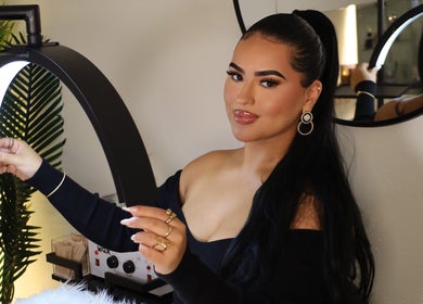 Aesthetician at Esthetics by Carolina Torres, LLC, in Orlando, Florida, US, adjusting a beauty lamp.