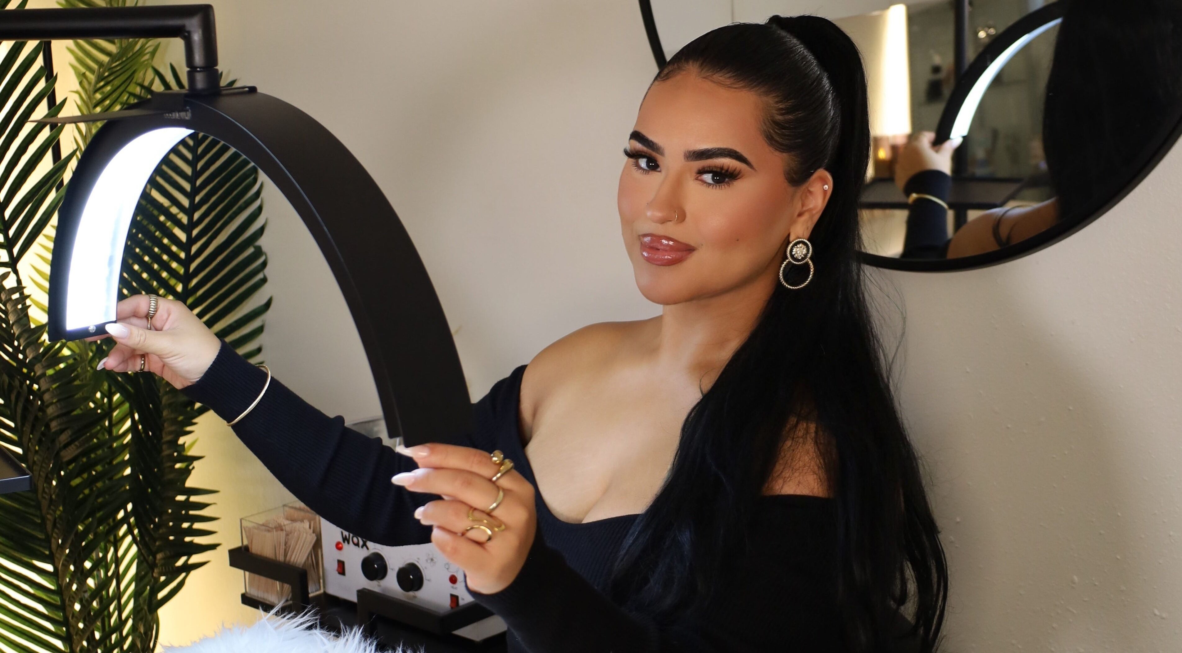 Aesthetician at Esthetics by Carolina Torres, LLC, in Orlando, Florida, US, adjusting a beauty lamp.