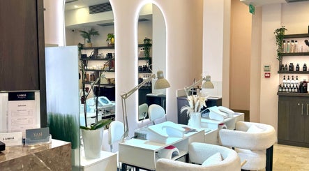 Elegant interior of LUMIÁ BEAUTY CHELSEA, London, England, GB, showcasing stylish manicure stations.