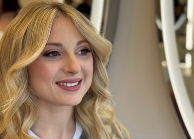 Woman smiling after beauty treatment at LUMIÁ BEAUTY CHELSEA, London, England, GB.