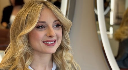Woman smiling after beauty treatment at LUMIÁ BEAUTY CHELSEA, London, England, GB.