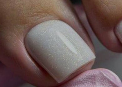 Close-up of elegant white manicured nails at LUMIÁ BEAUTY CHELSEA in London, England, GB.