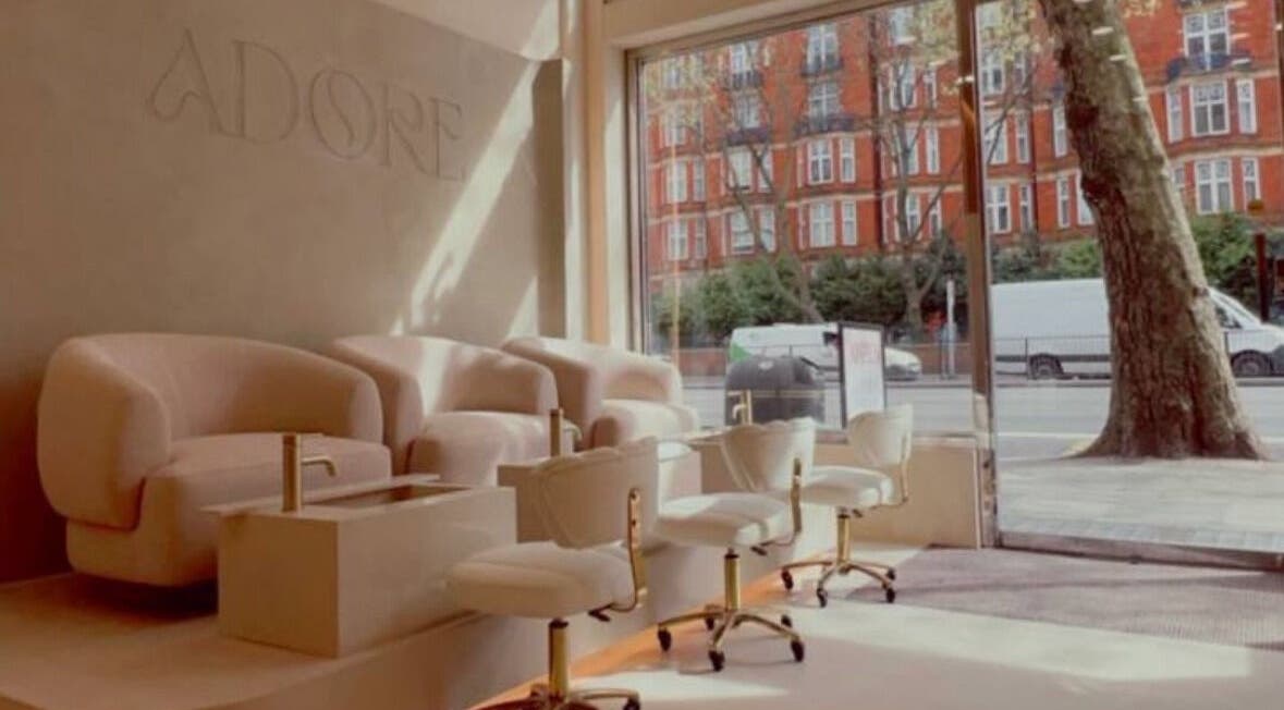 Modern nail salon interior at LUMIÁ NAILS MARYLEBONE, London, England, GB with plush seating and street view.