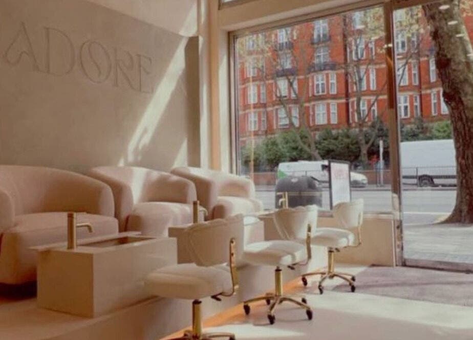 Luxurious seating area at LUMIÁ NAILS MARYLEBONE, London, England, GB, with plush chairs and natural light.