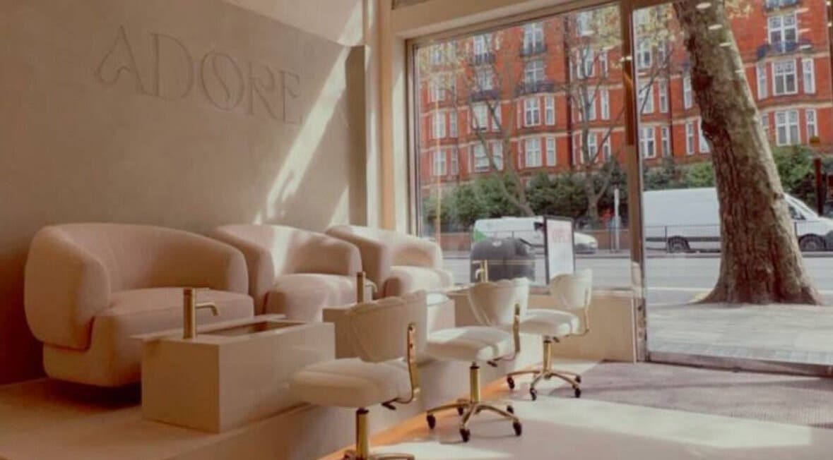 Luxurious seating area at LUMIÁ NAILS MARYLEBONE, London, England, GB, with plush chairs and natural light.