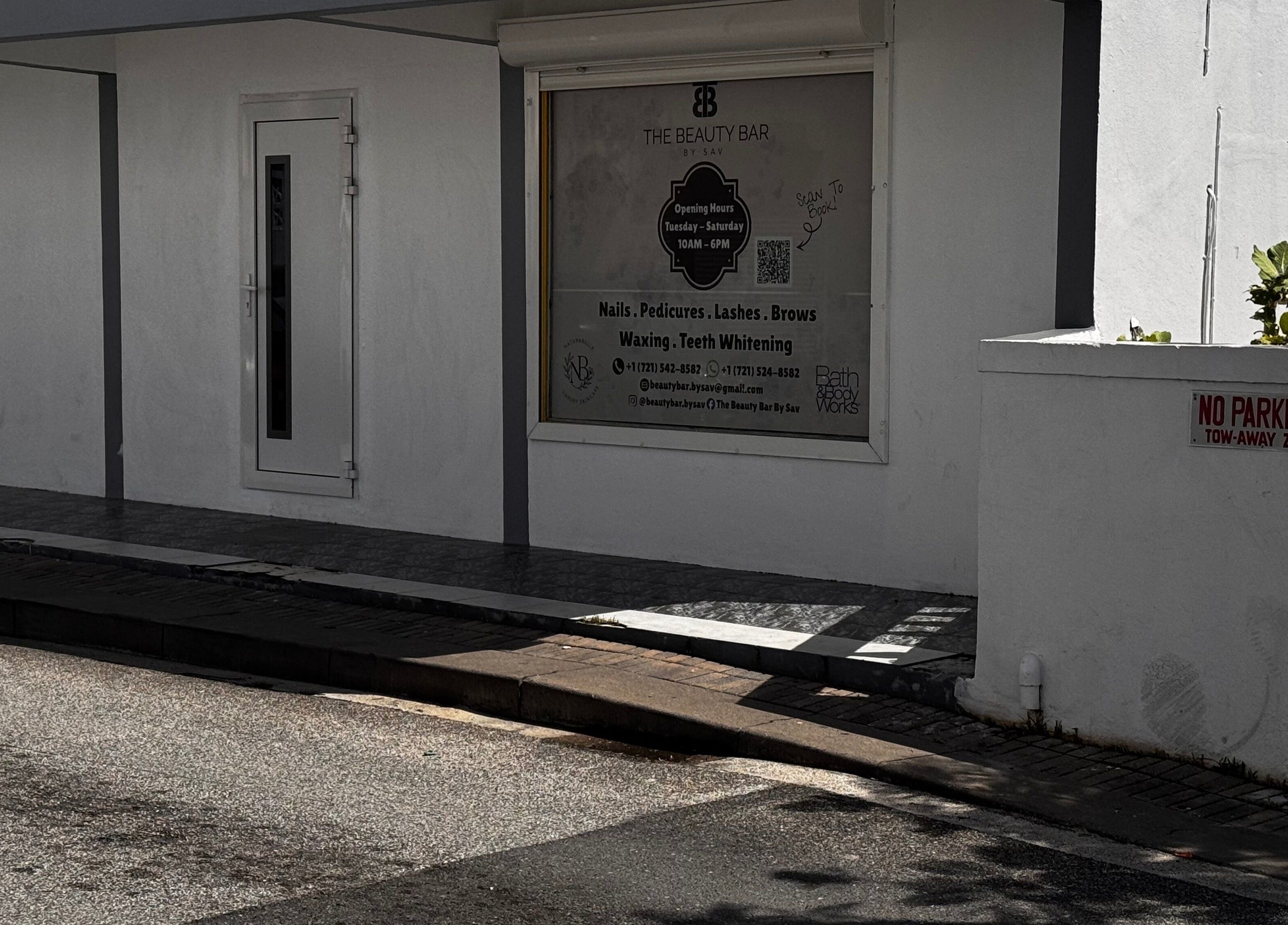 Exterior view of The Beauty Bar By Sav & Co at Philipsburg, SX, showcasing service offerings and entrance.