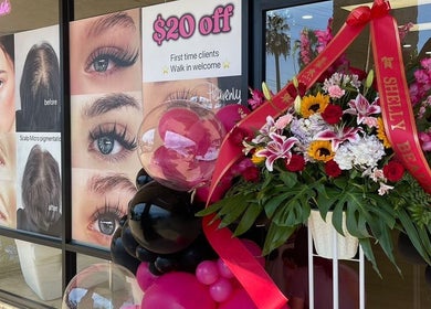 Shelly Beauty Studio entrance in Monrovia, California, with vibrant floral decor and service posters.