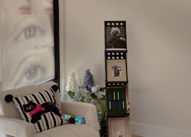 Inviting corner at Shelly Beauty Studio, Monrovia, California with a stylish chair and floral decor.