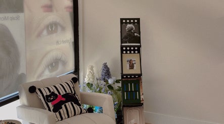 Inviting corner at Shelly Beauty Studio, Monrovia, California with a stylish chair and floral decor.