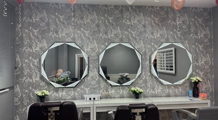 Elegant styling station at Armley Beauty Lounge, Leeds, England, GB with octagonal mirrors and chic decor.