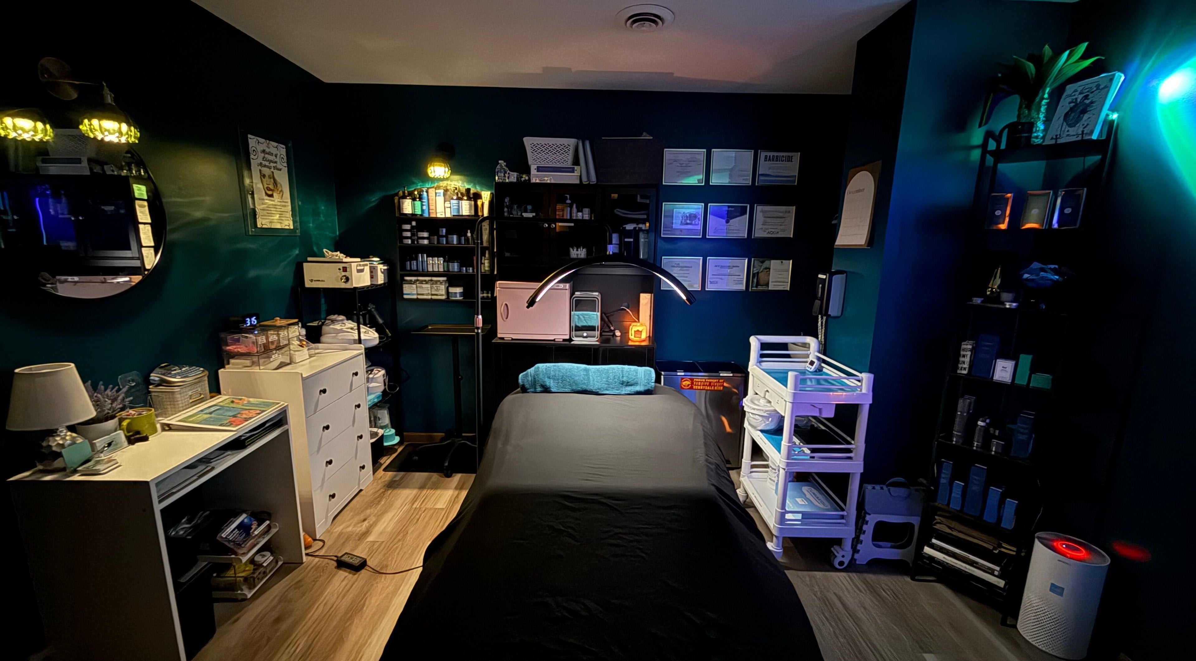 Relaxing treatment room at Esthetics By Kyrsta in North Canton, Ohio, US featuring a cozy massage bed.