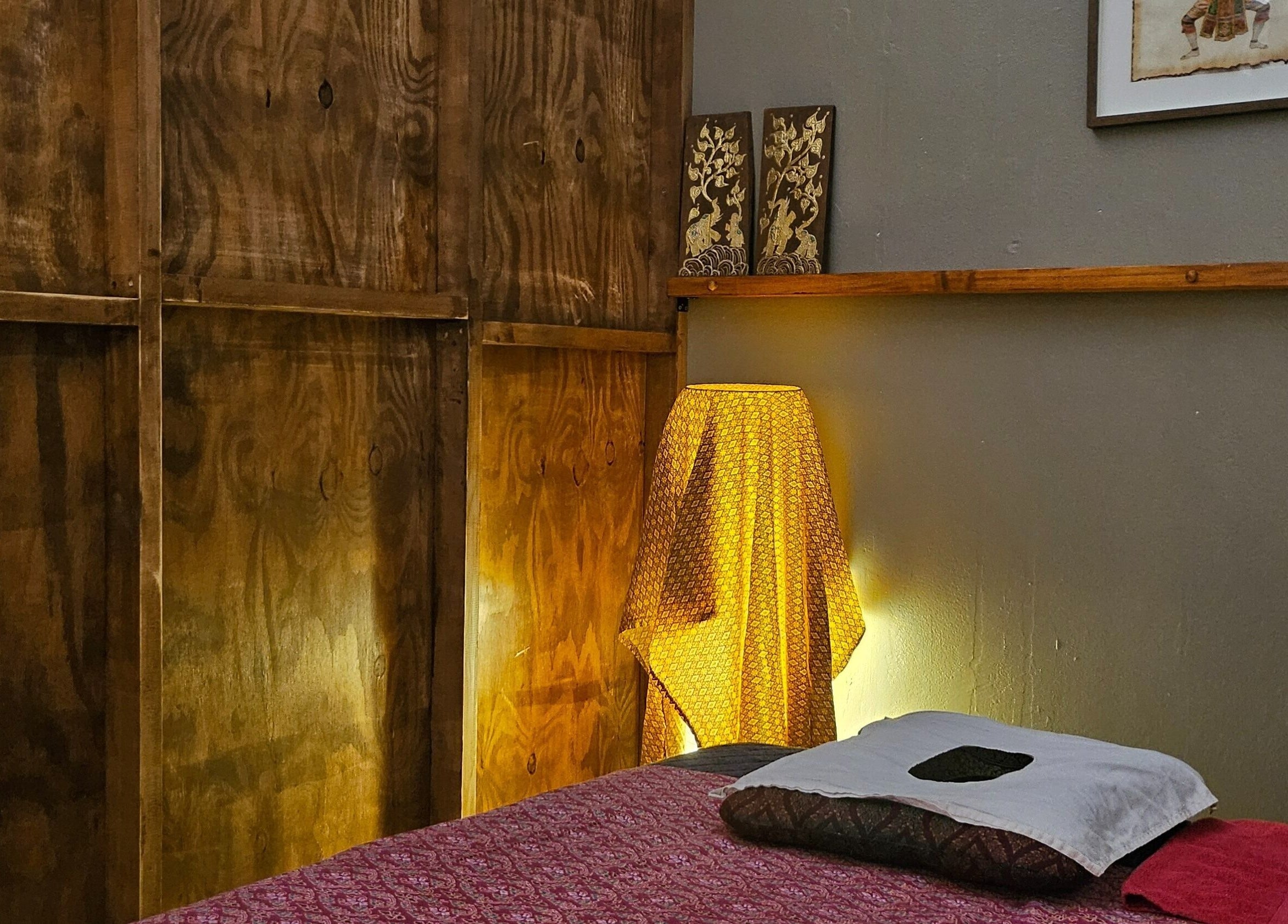 Cozy massage room at Piyawat Thai Massage Maylands, Western Australia, AU, featuring soft lighting and cultural decor.