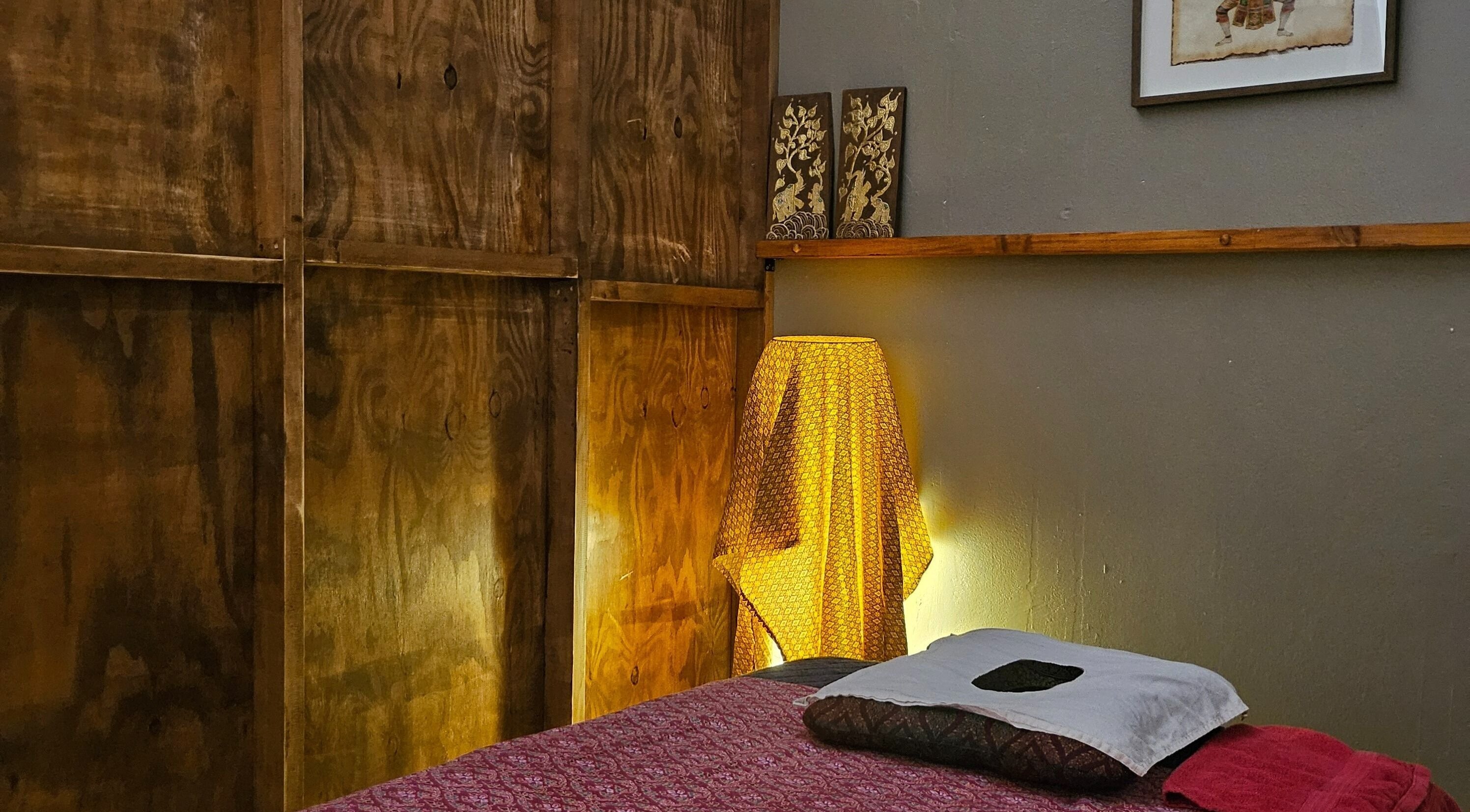 Cozy massage room at Piyawat Thai Massage Maylands, Western Australia, AU, featuring soft lighting and cultural decor.